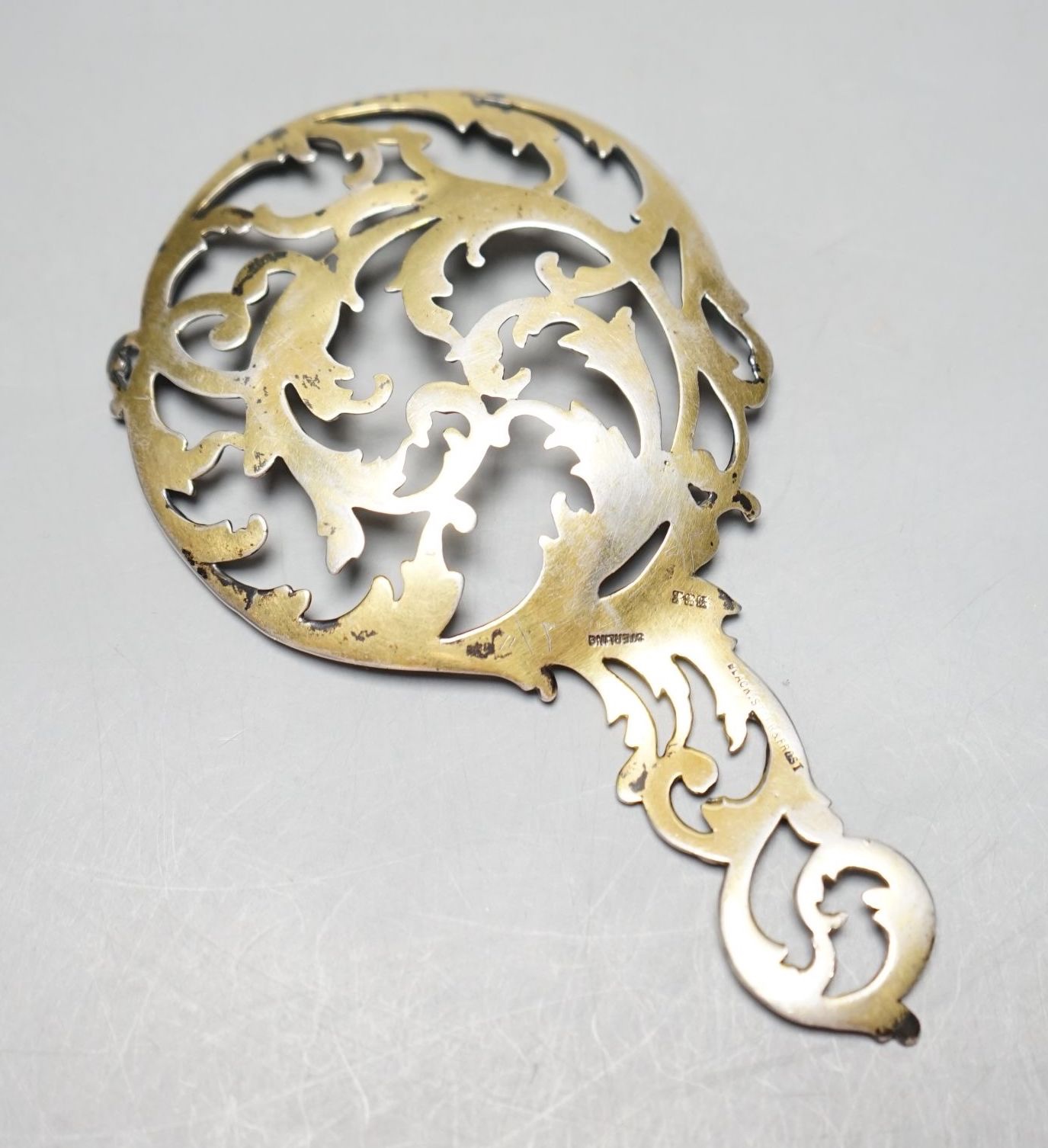 An American Black, Starr & Frost parcel gilt sterling ornamental spoon, of scrolling openwork form, 12.7cm.